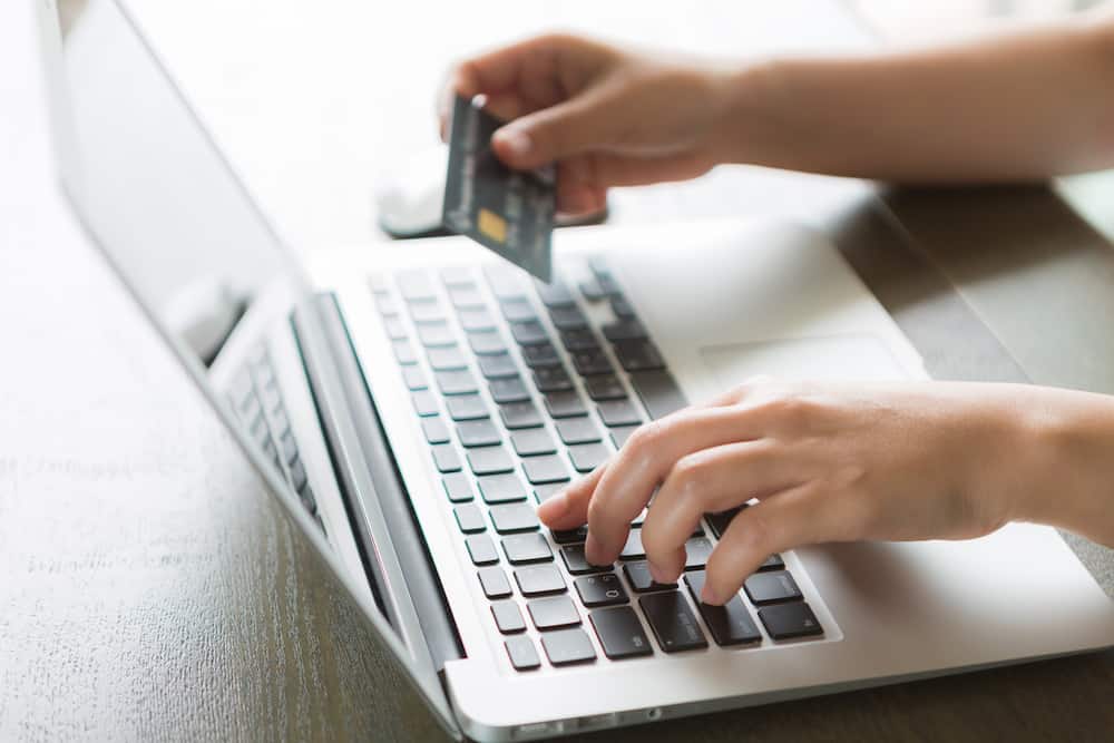 Hands,Holding,A,Credit,Card,And,Using,Laptop,Computer,For