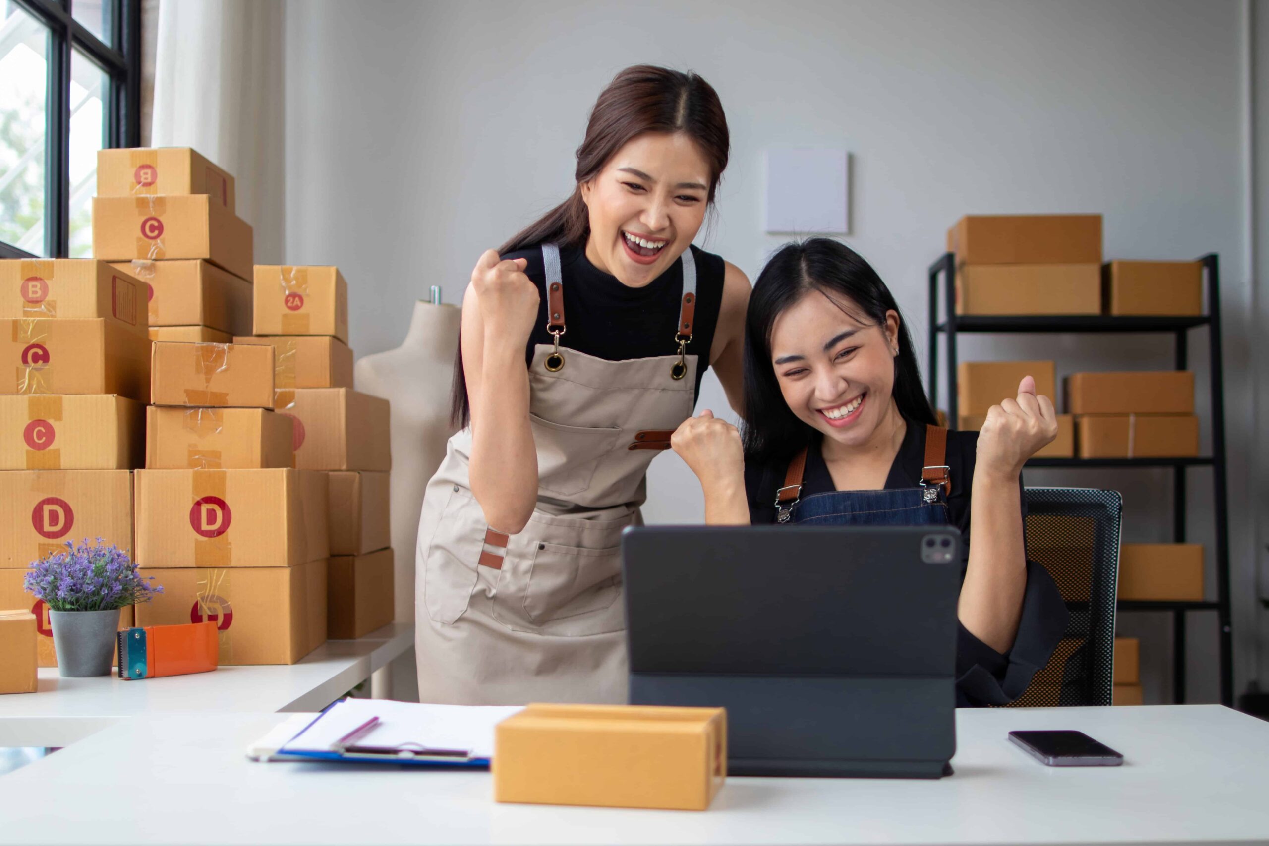 Two small business owners celebrating their top ranks with cost-effective SEO services in Australia